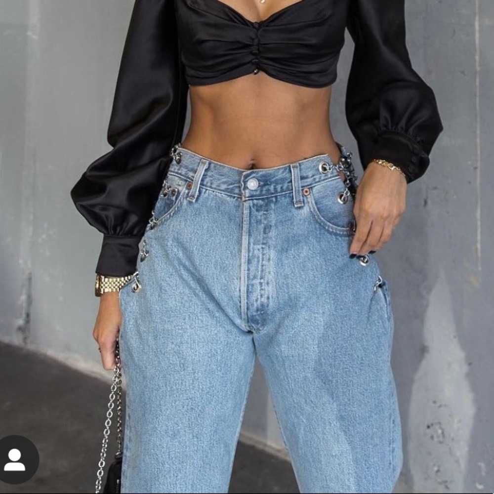 Denim jeans with exposed side metal chain closure